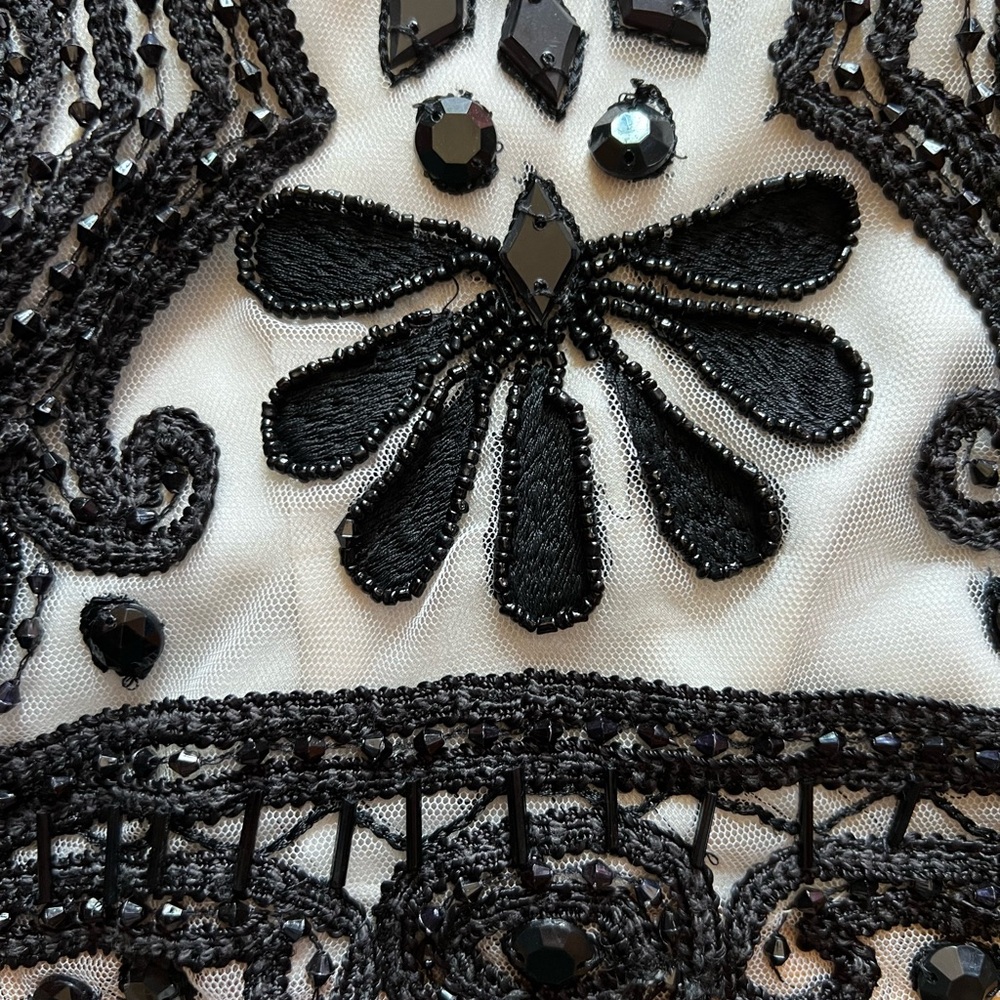 White mesh top with dramatic black beads. Dressy, cocktail.